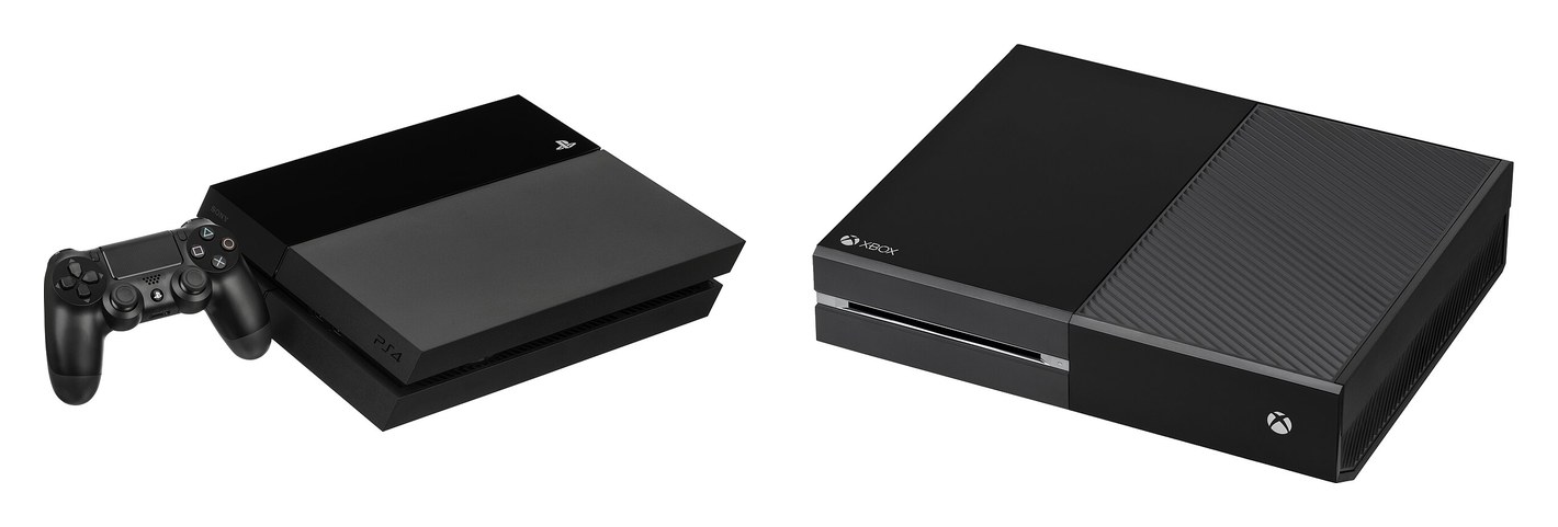 A PlayStation 4 with its controller, and an Xbox One, both black, side by side.