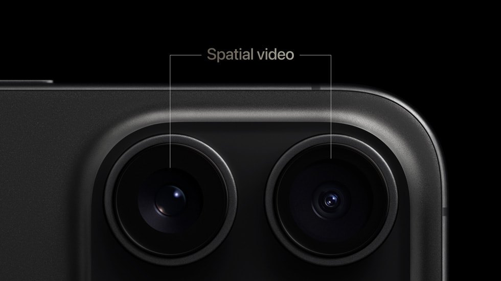 Close-up of two rear camera lenses on an iPhone 15 Pro, marked "Spatial video".