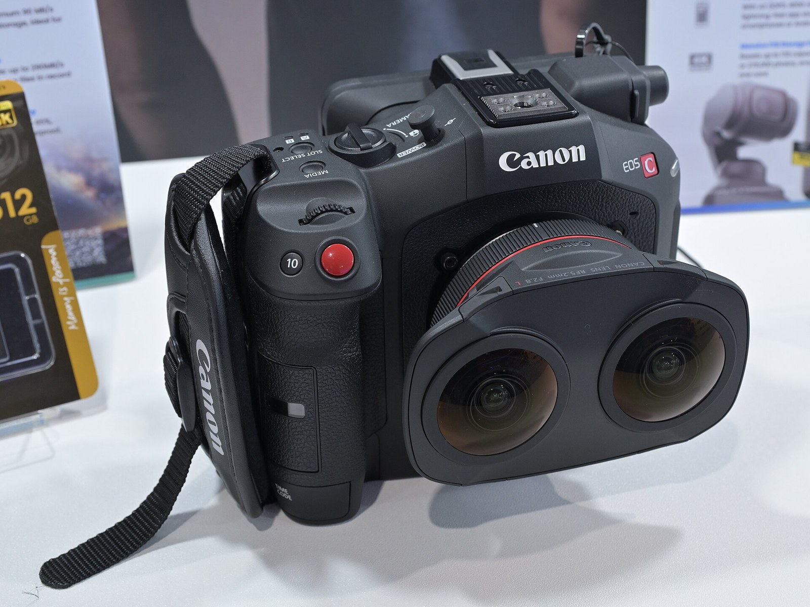 A Canon EOS R5 C camera fitted with the RF5.2mm dual fisheye lens, which has two bulging lenses side by side.