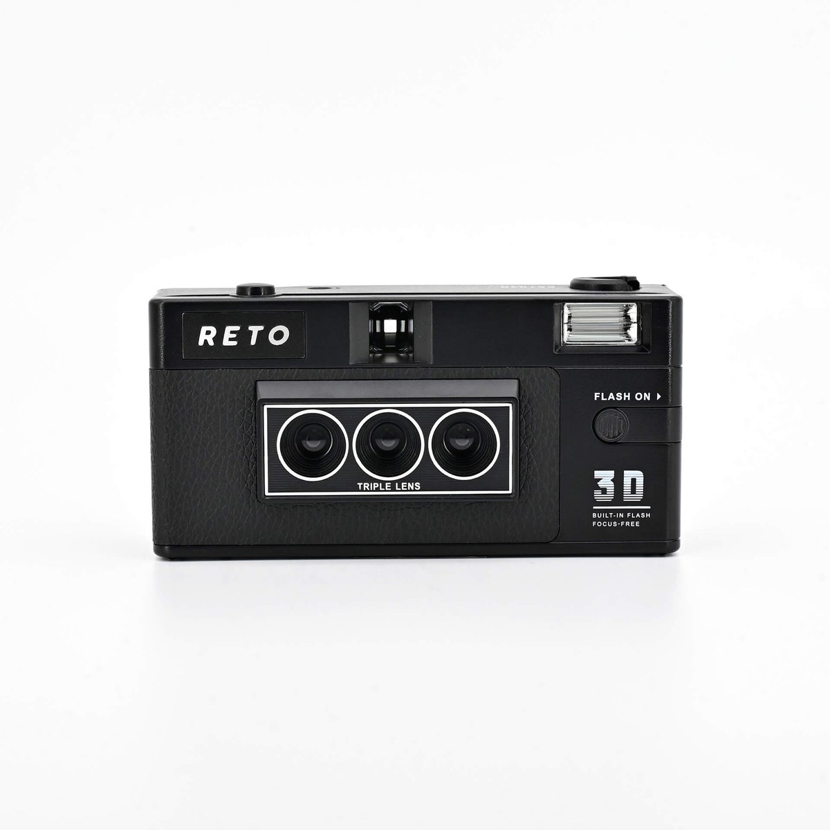 The front of a RETO3D Classic, a black 35mm film camera with three small lenses in a row.