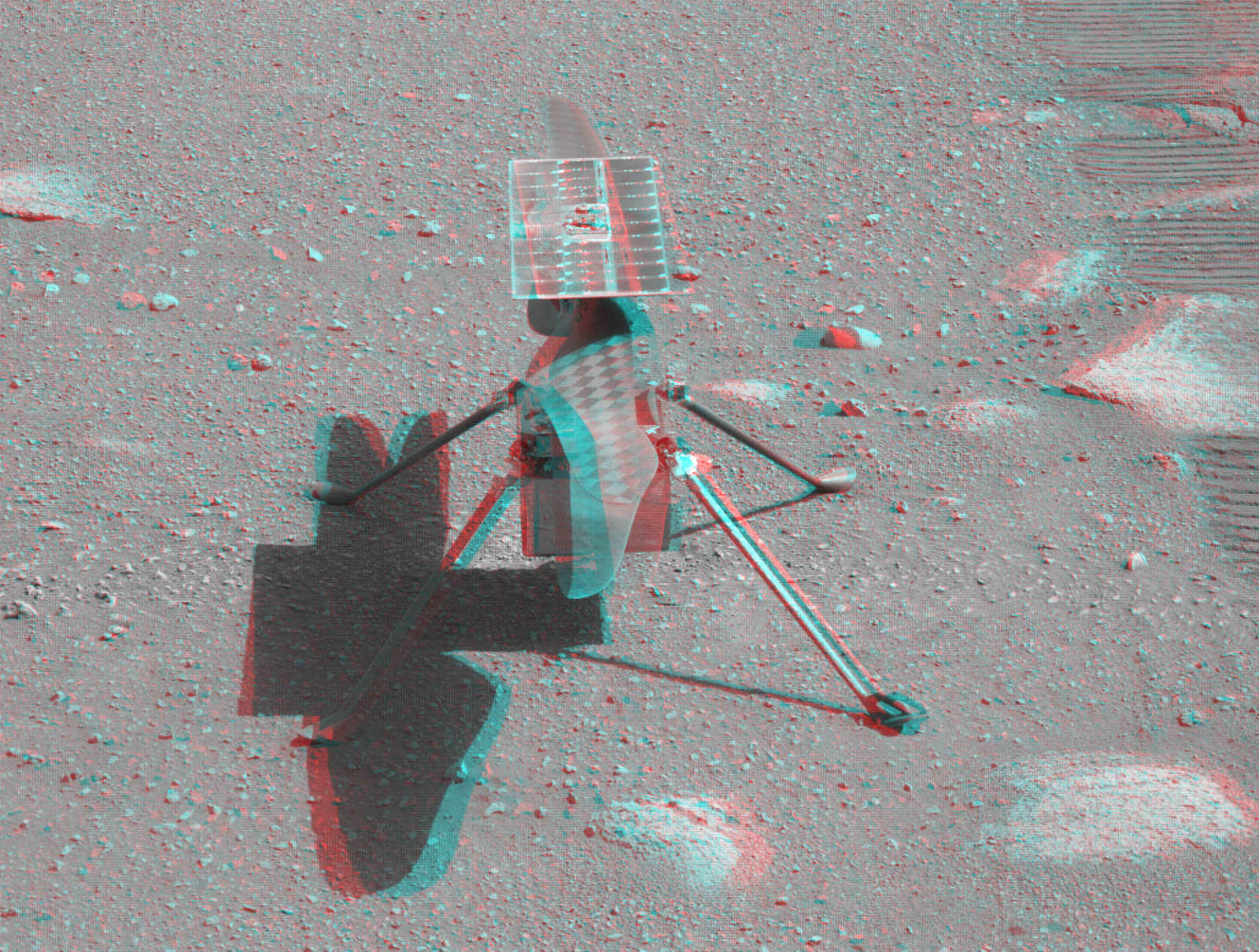 Red-cyan anaglyph 3D picture of NASA's Ingenuity helicopter standing on the surface of Mars