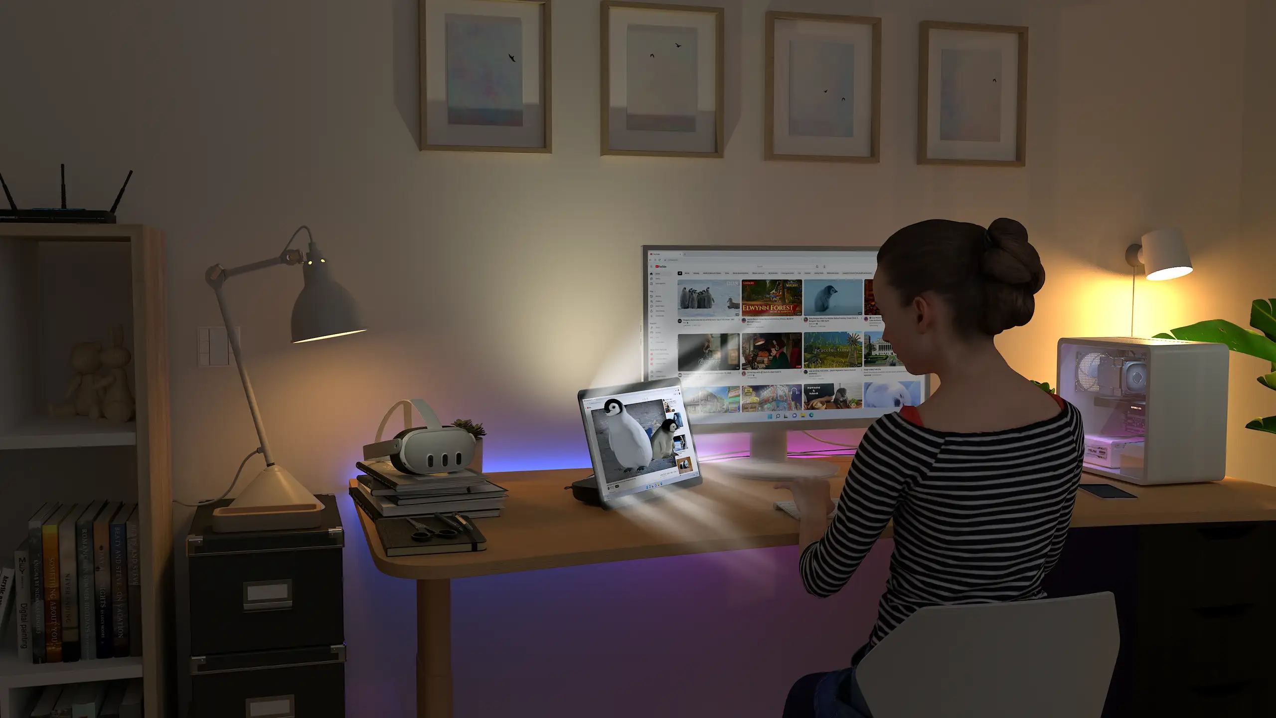 A person at a desk with a desktop monitor, and the Owl3D Shift standing beside it as a smaller second screen.