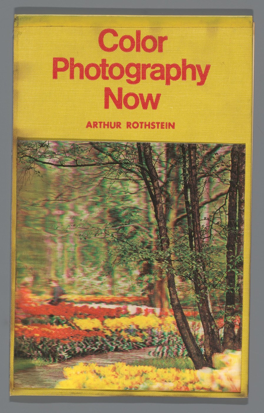 The yellow cover of the 1970 book Color Photography Now by Arthur Rothstein, with a lenticular picture of a garden of tulips and trees set into it.