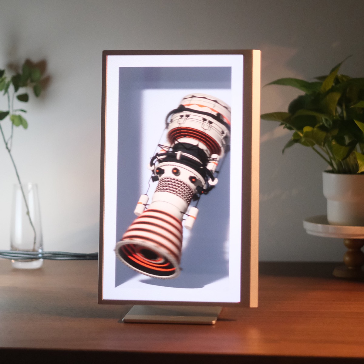 A Looking Glass 16-inch Light Field Display standing upright on a desk, showing a rocket engine model.