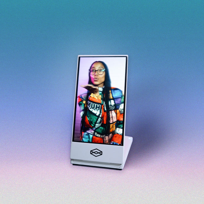 A Looking Glass Go in its white casing, showing a photo of a person.