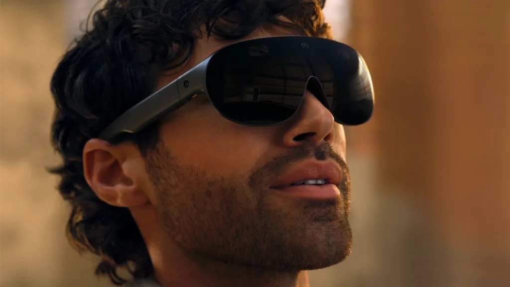 A man wearing Meta VR Glasses, seen from the side, looking up.