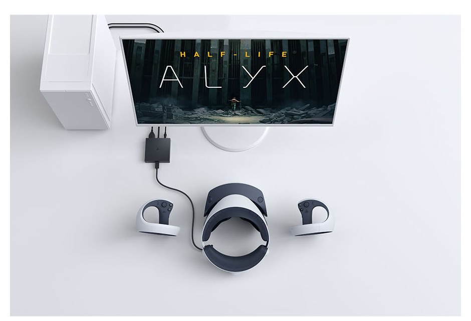 A PlayStation VR2 PC adapter on a desk, cabled to a PC tower and a monitor showing Half-Life: Alyx, with the headset and two controllers in front of it.